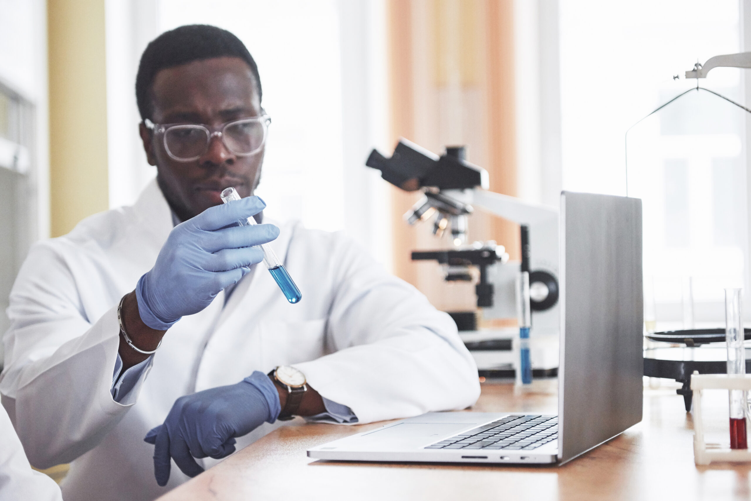 An African American worker works in a laboratory conducting experiments